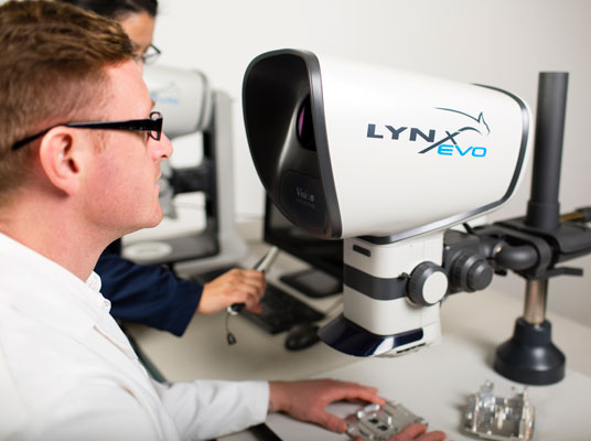 Male engineer operating Lynx EVO stereo microscope
