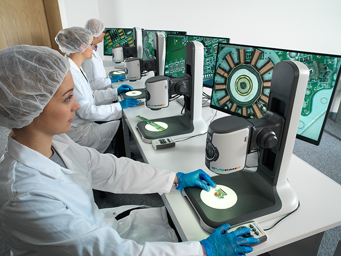 Operators inspecting PCBs with EVO Cam II
