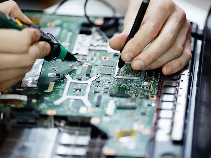 AdobeStock_136939755-700×525 Close up of someone soldering electronics on a PCB